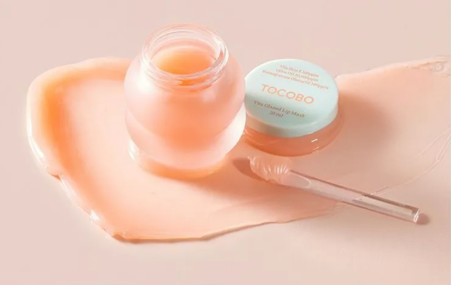 Tocoto skincare product with jar and applicator on a soft pink background