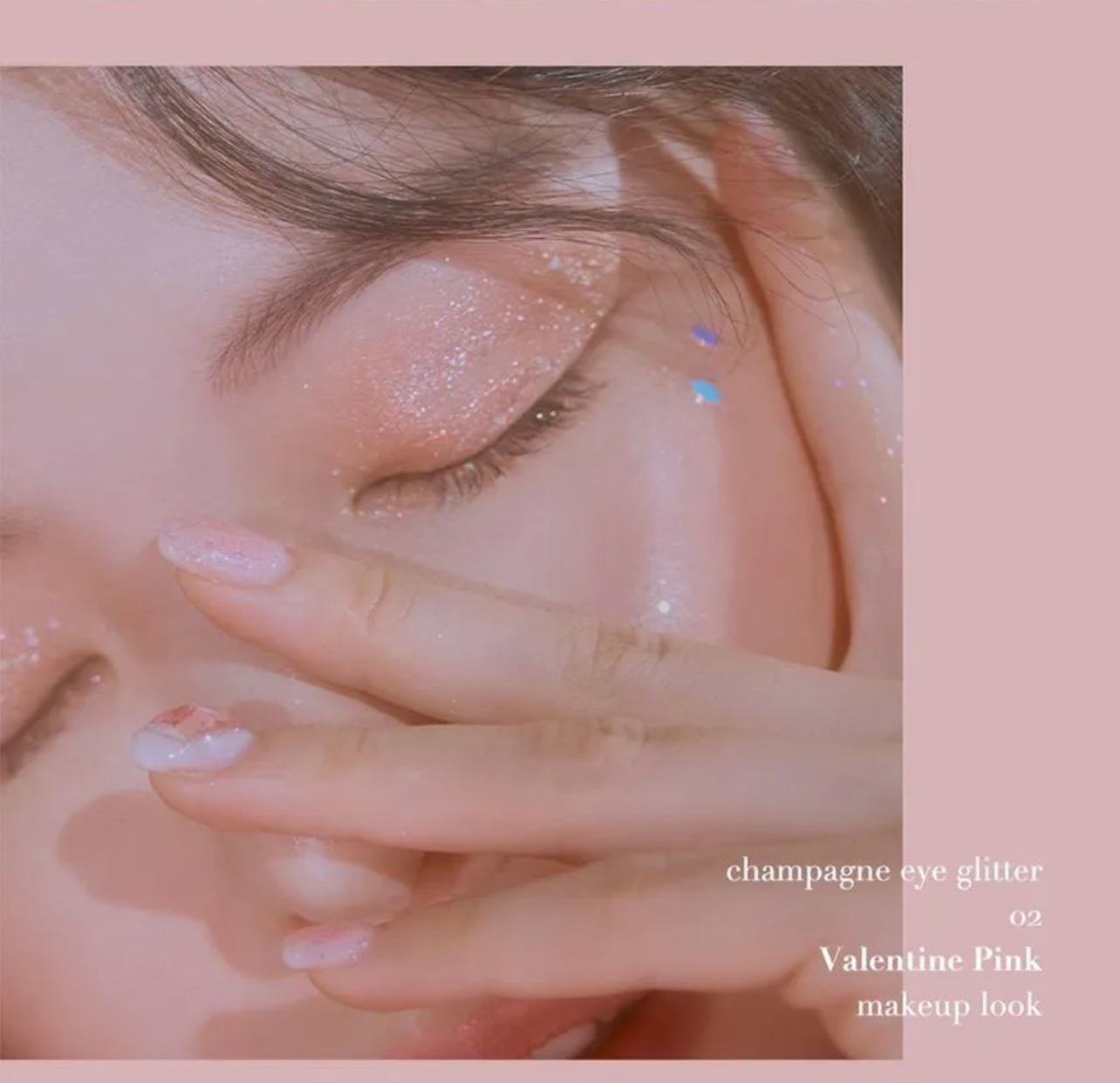 Close-up of a person with champagne eye glitter and pink makeup on a soft pink background.