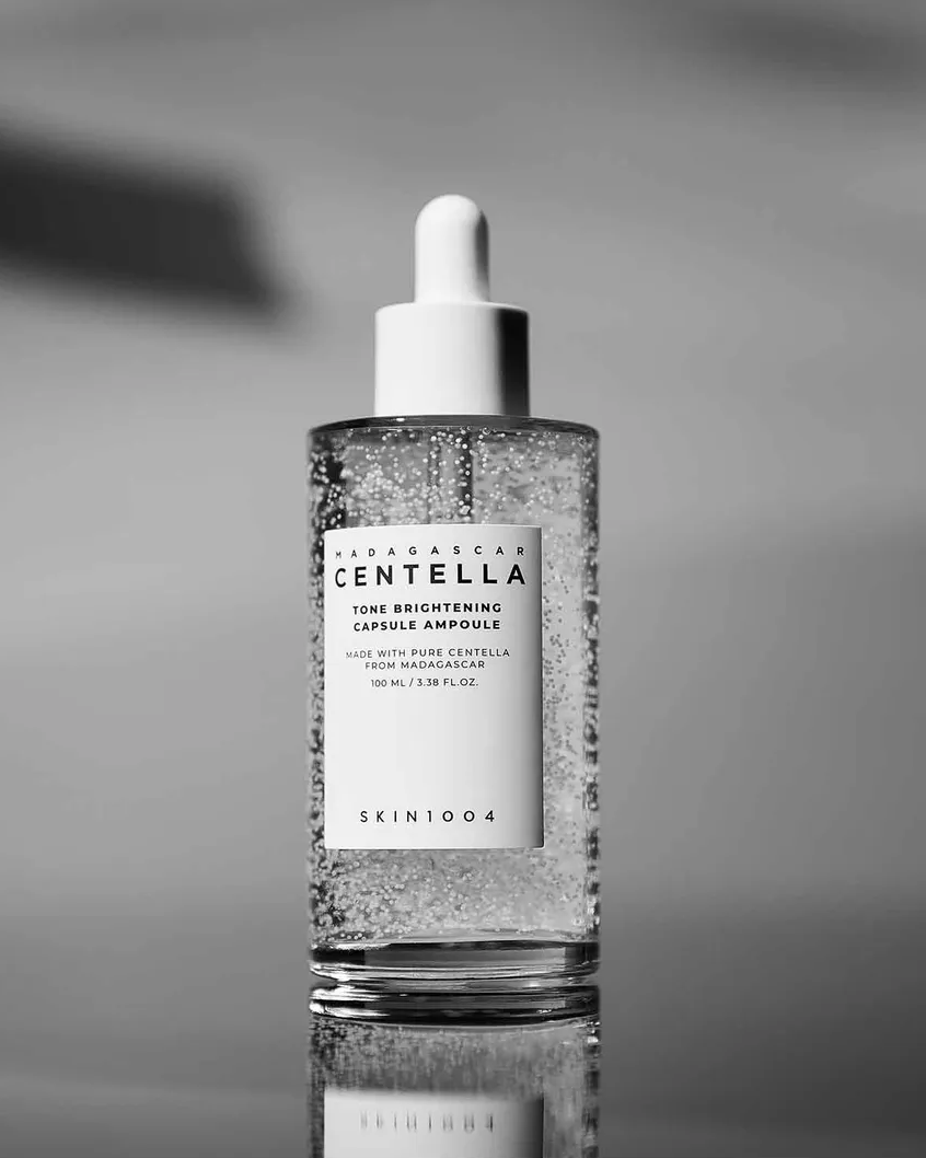 Skintouch Centella bottle with dropper on a reflective surface