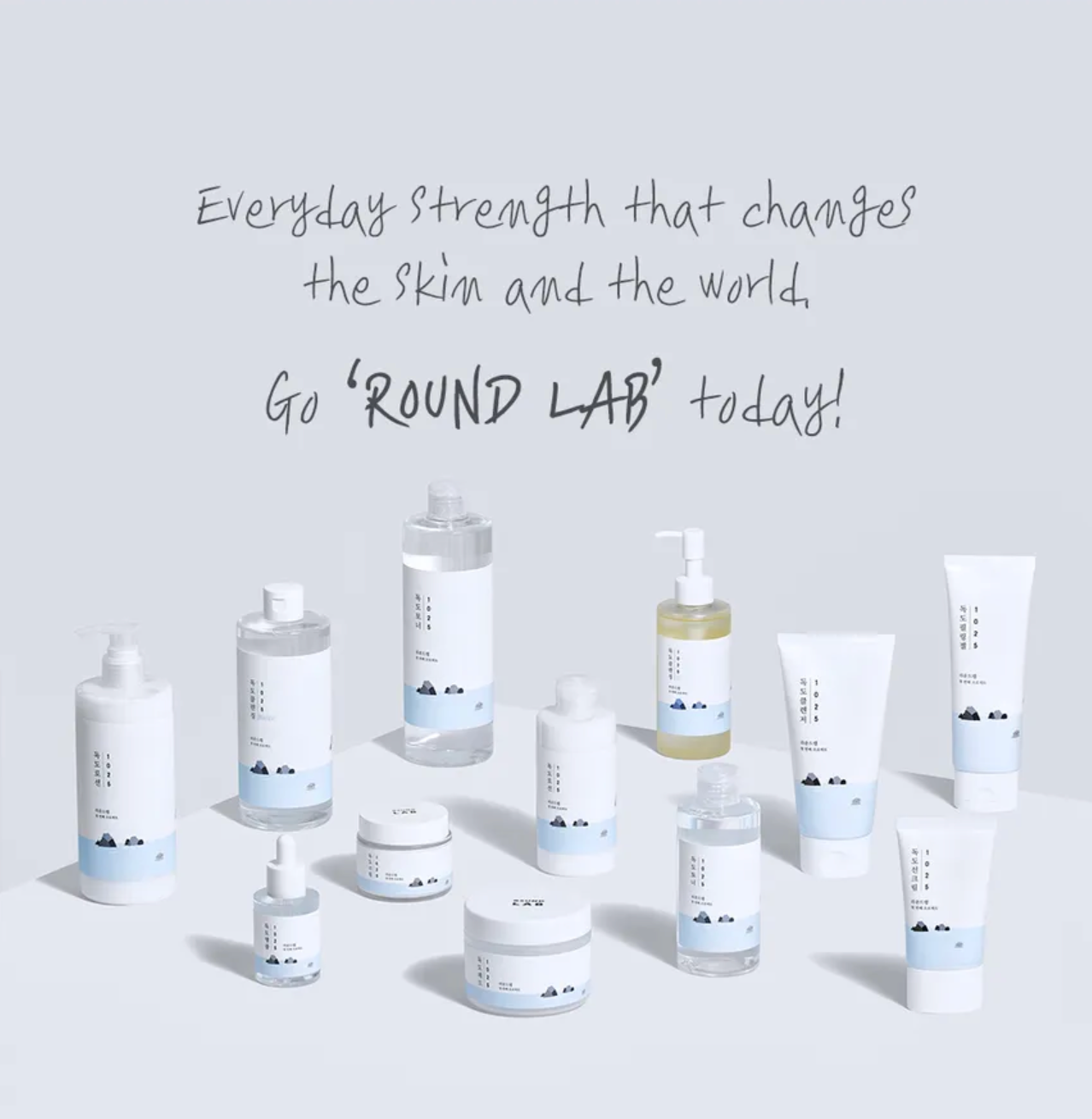 Collection of Round Lab skincare products on a light gray background with promotional text.