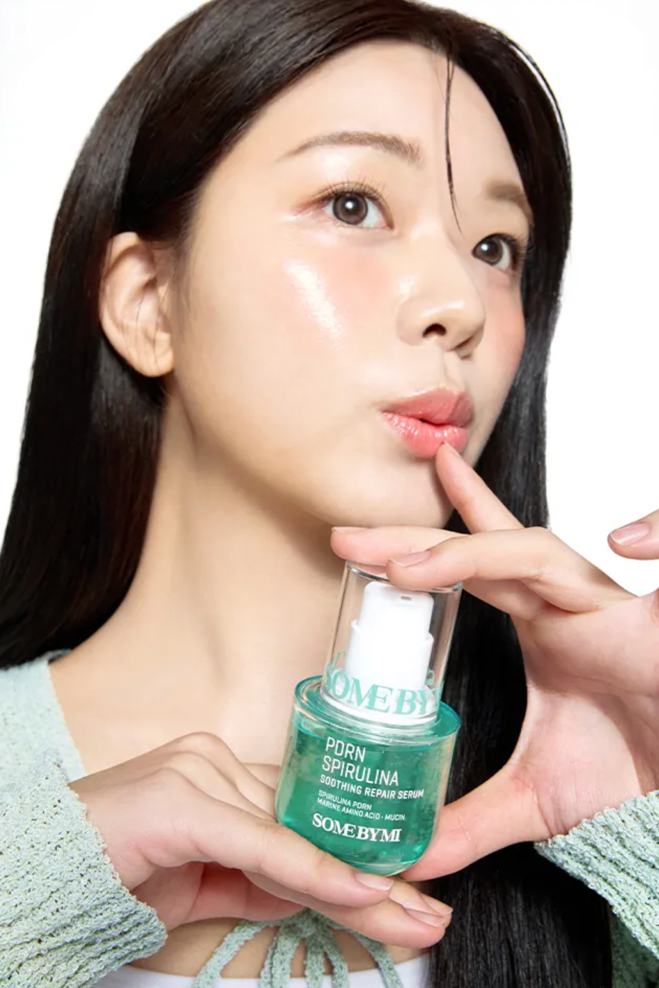 Woman holding a skincare product with a white background