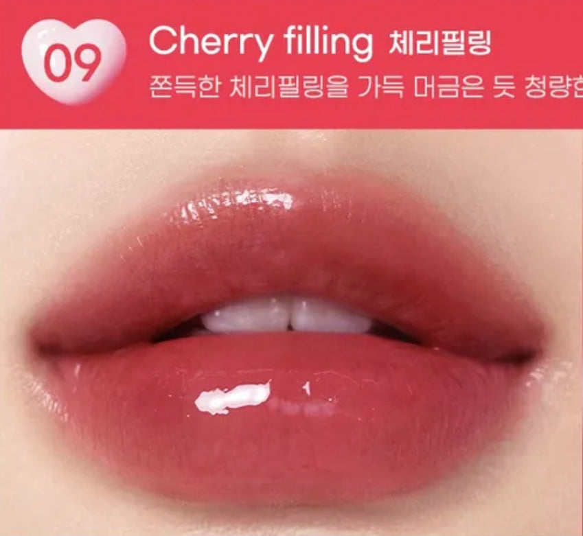 Close-up of lips with cherry filling lipstick on a red background