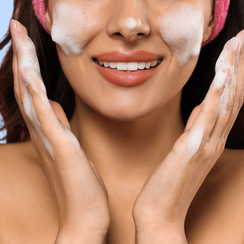 Woman applying a facial mask with her hands