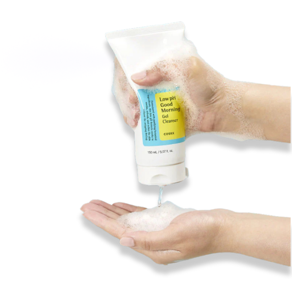 Hand holding a tube of 'Good Morning Gel Cleanser' with foam being dispensed onto the palm.