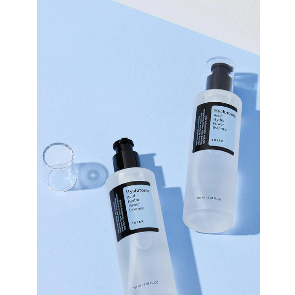 Two bottles of Cohea skincare products on a light blue background
