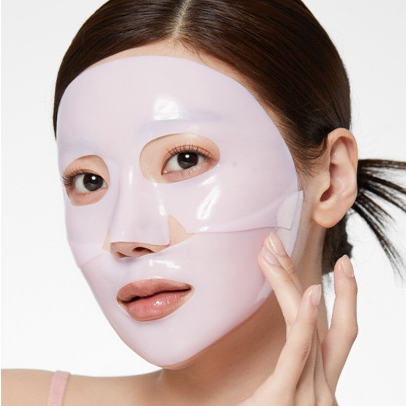 Woman wearing a pink face mask with a plain background
