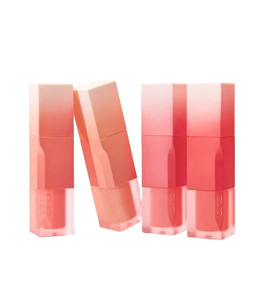 Four lip glosses with gradient colors on a white background