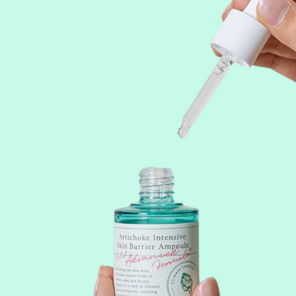 Bottle of Artichoke Intensive Skin Barrier Ampoule with dropper on a light green background