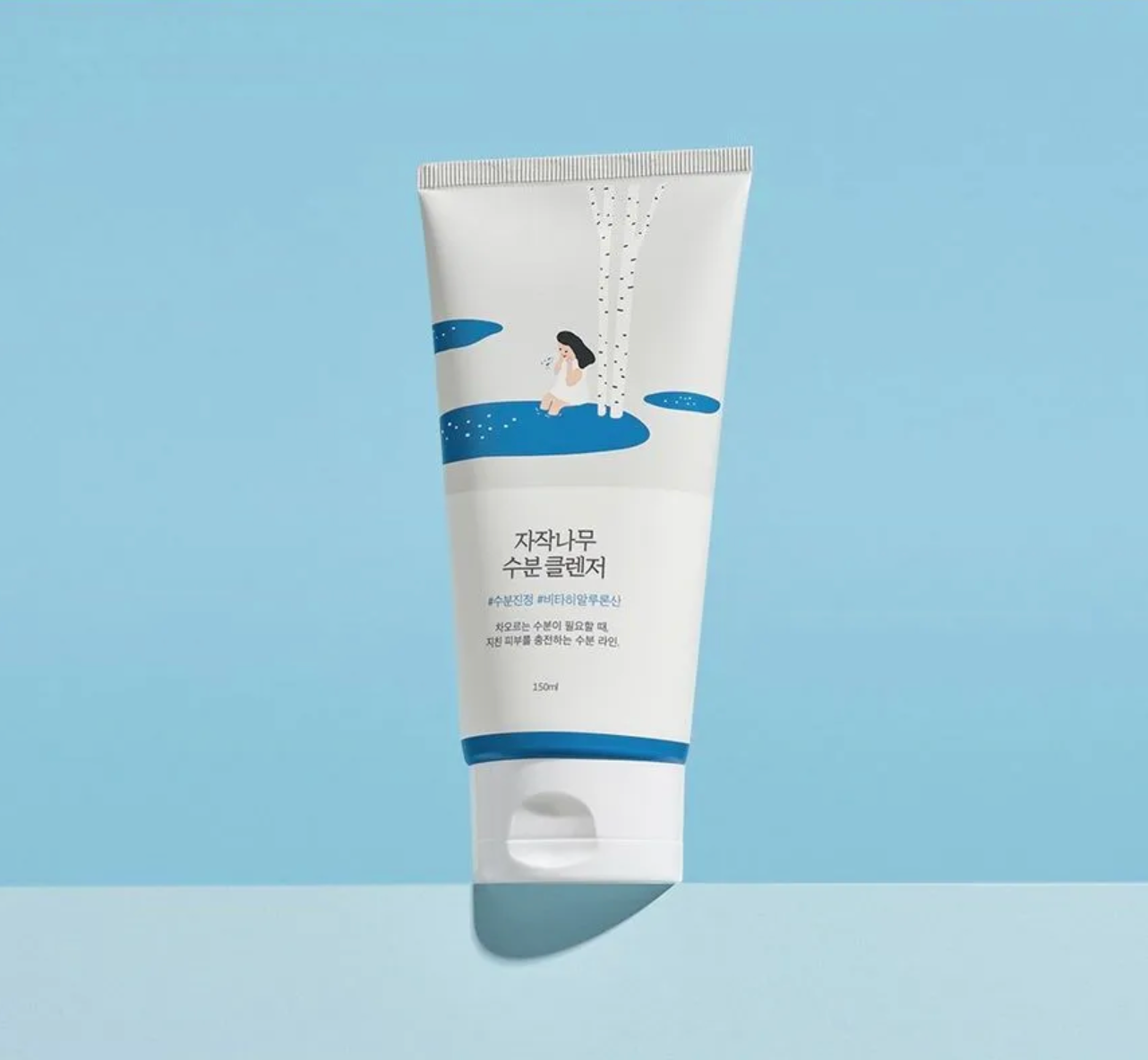 Tube of skincare product with a blue and white design on a light blue background