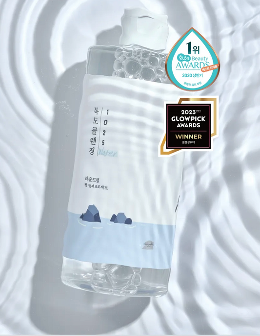 Bottle with a label on a white background, featuring awards and text.