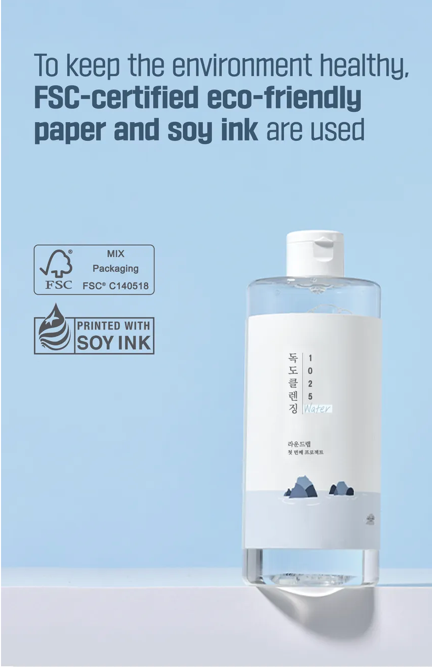 Bottle with FSC-certified eco-friendly paper and soy ink label on a light blue background