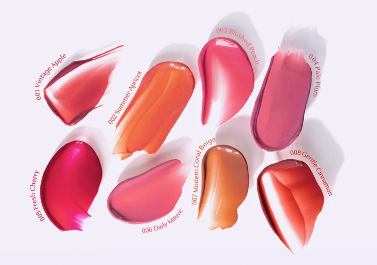 Set of lip gloss shades displayed in a circular arrangement on a white background.