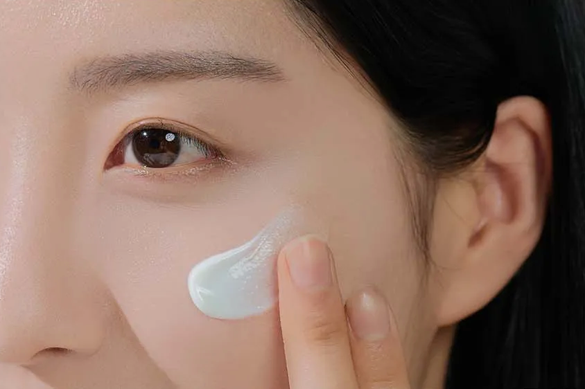 Person applying cream to their face