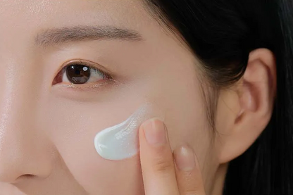 Person applying cream to their face