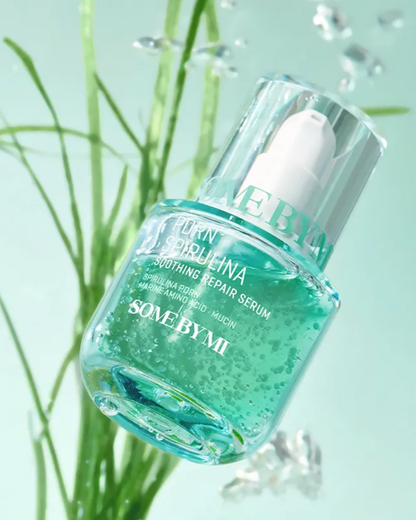 Some By Mi serum bottle with green liquid on a light green background