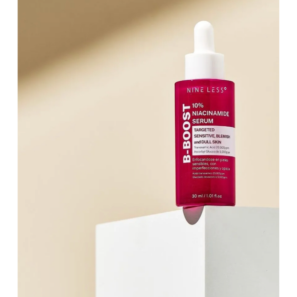 Nine Less B-Boost Niacinamide Serum bottle with dropper on a beige background