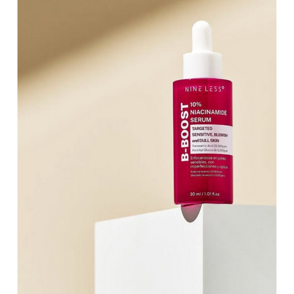 Nine Less B-Boost Niacinamide Serum bottle with dropper on a beige background