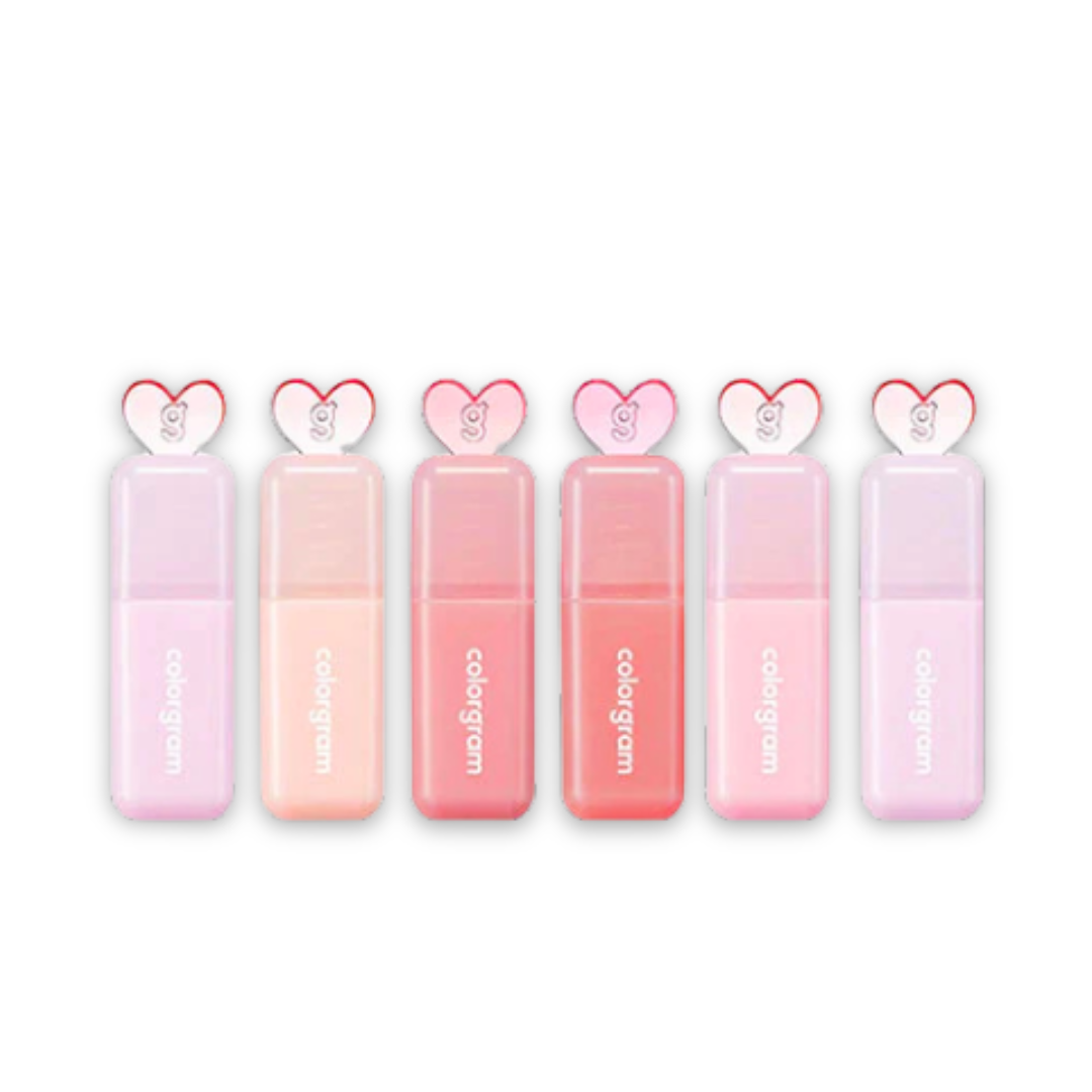 Set of pink lip glosses with heart-shaped caps on a white background