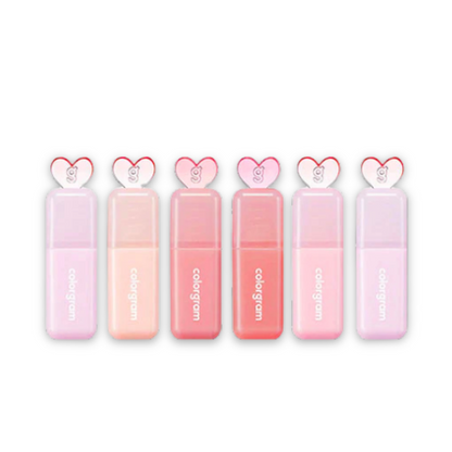 Set of pink lip glosses with heart-shaped caps on a white background