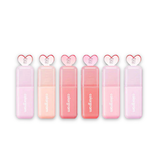 Set of pink lip glosses with heart-shaped caps on a white background