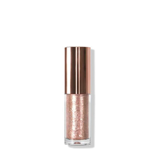 Rose gold glittery nail polish bottle on a white background
