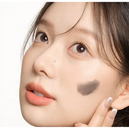 Close-up of a person's face with makeup on a white background