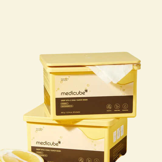 Two yellow boxes of Medicube Deep Vita C Daily Quick Mask on a beige background