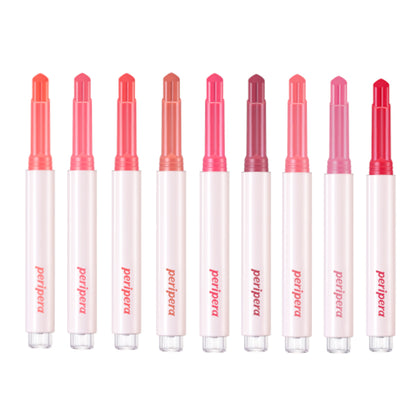 Row of Proaana lip glosses with red and pink caps on a white background