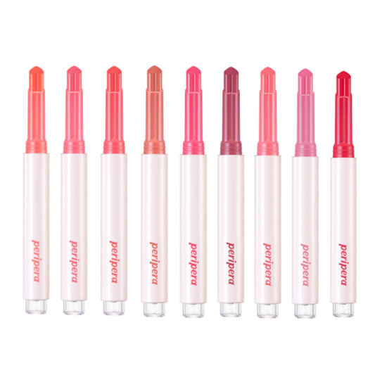 Row of Proaana lip glosses with red and pink caps on a white background